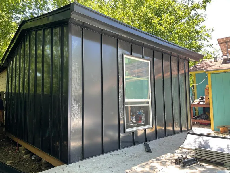 Black standing seam metal wall panels for Roof Inspection in Addison